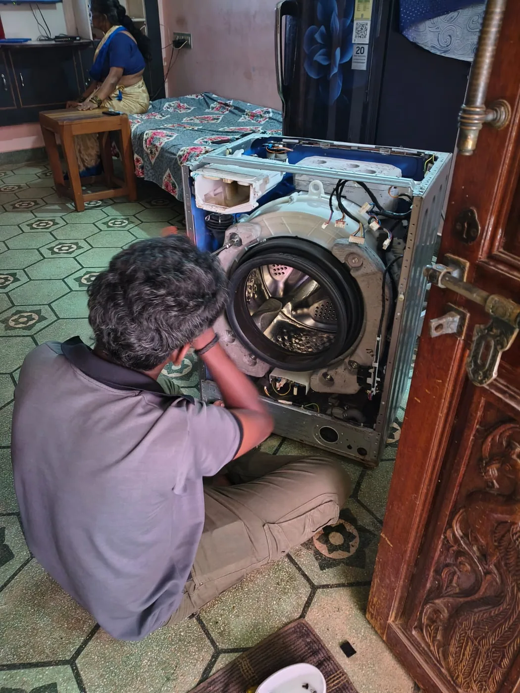 Technician servicing a washing machine drum