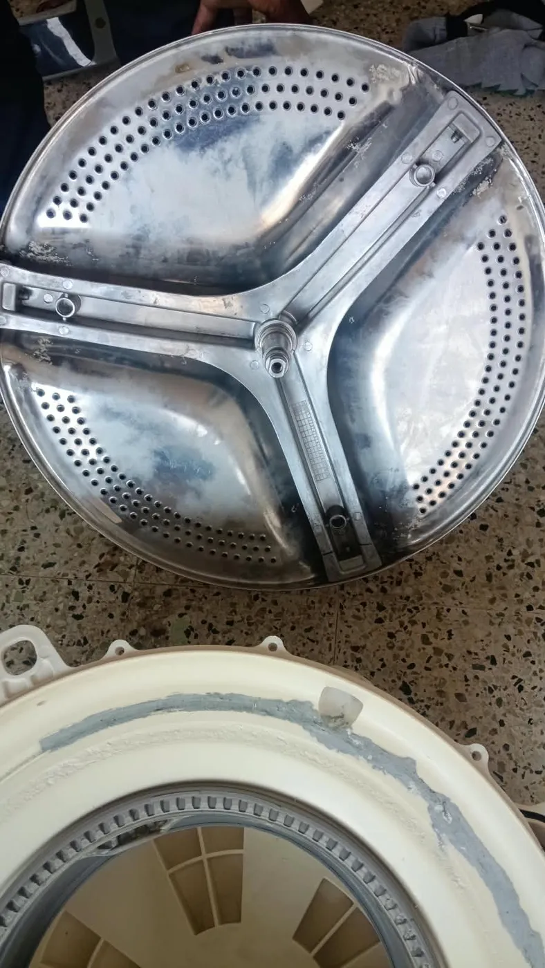 Close view of a washing machine's perforated inner drum